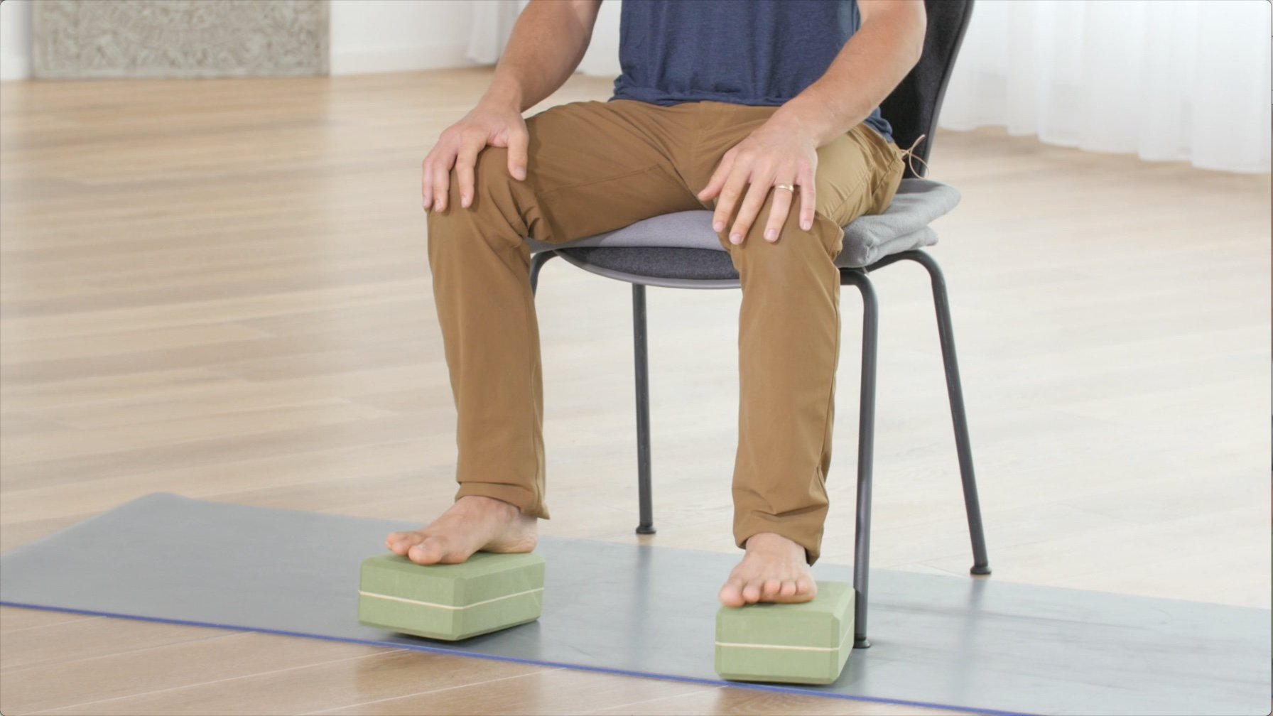 seated meditation posture on chair with props