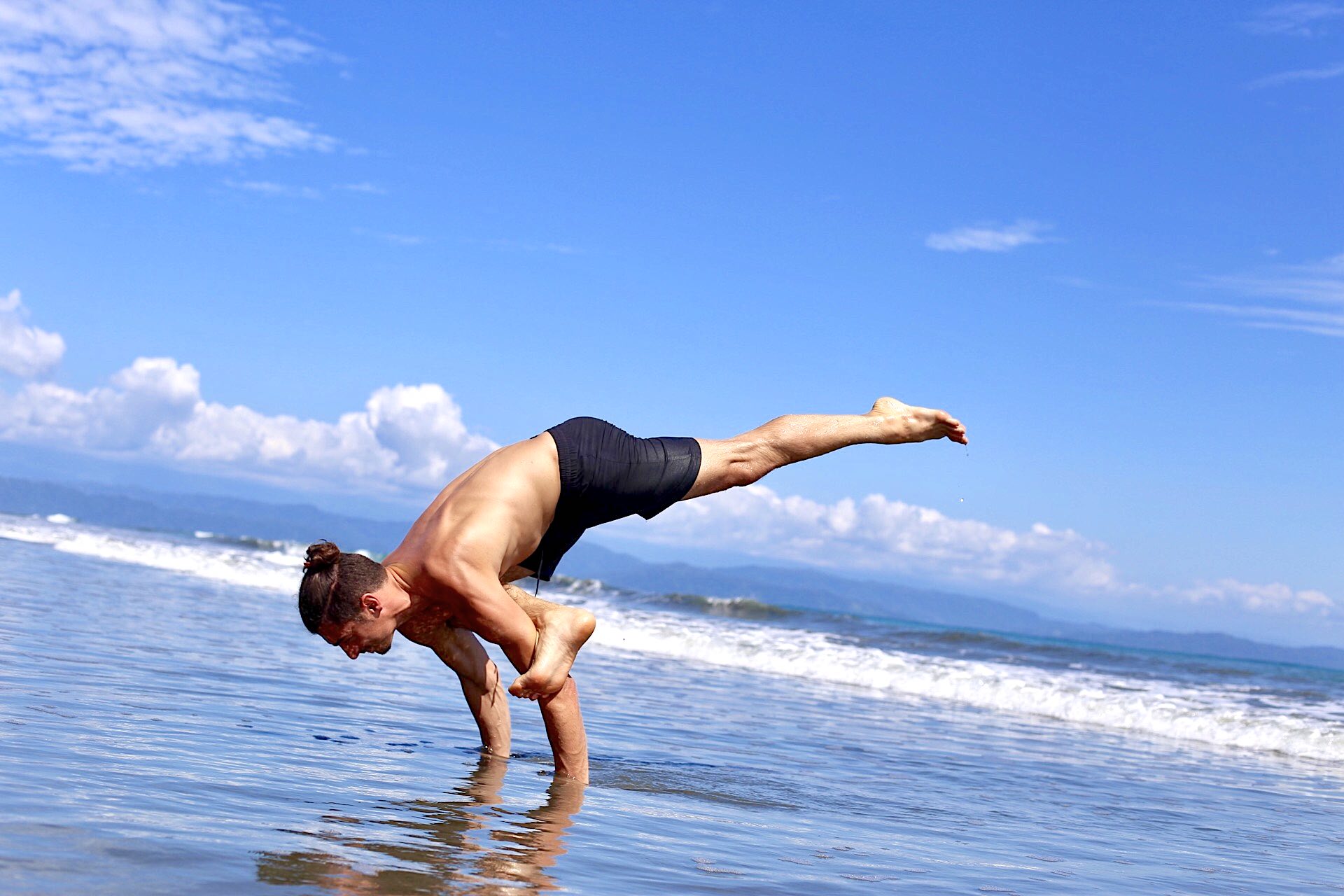 flying pigeon at the beach yoga for strength and flexibility